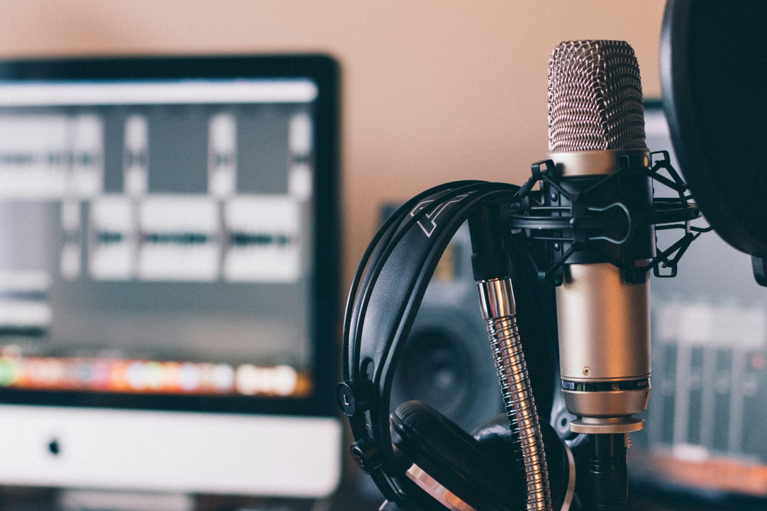 image of a computer and a microphone used to record a podcast